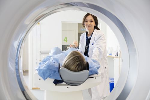 Female doctor assisting a patient taking an MRI