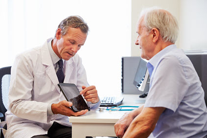 Male physician going over results with an elderly male patient